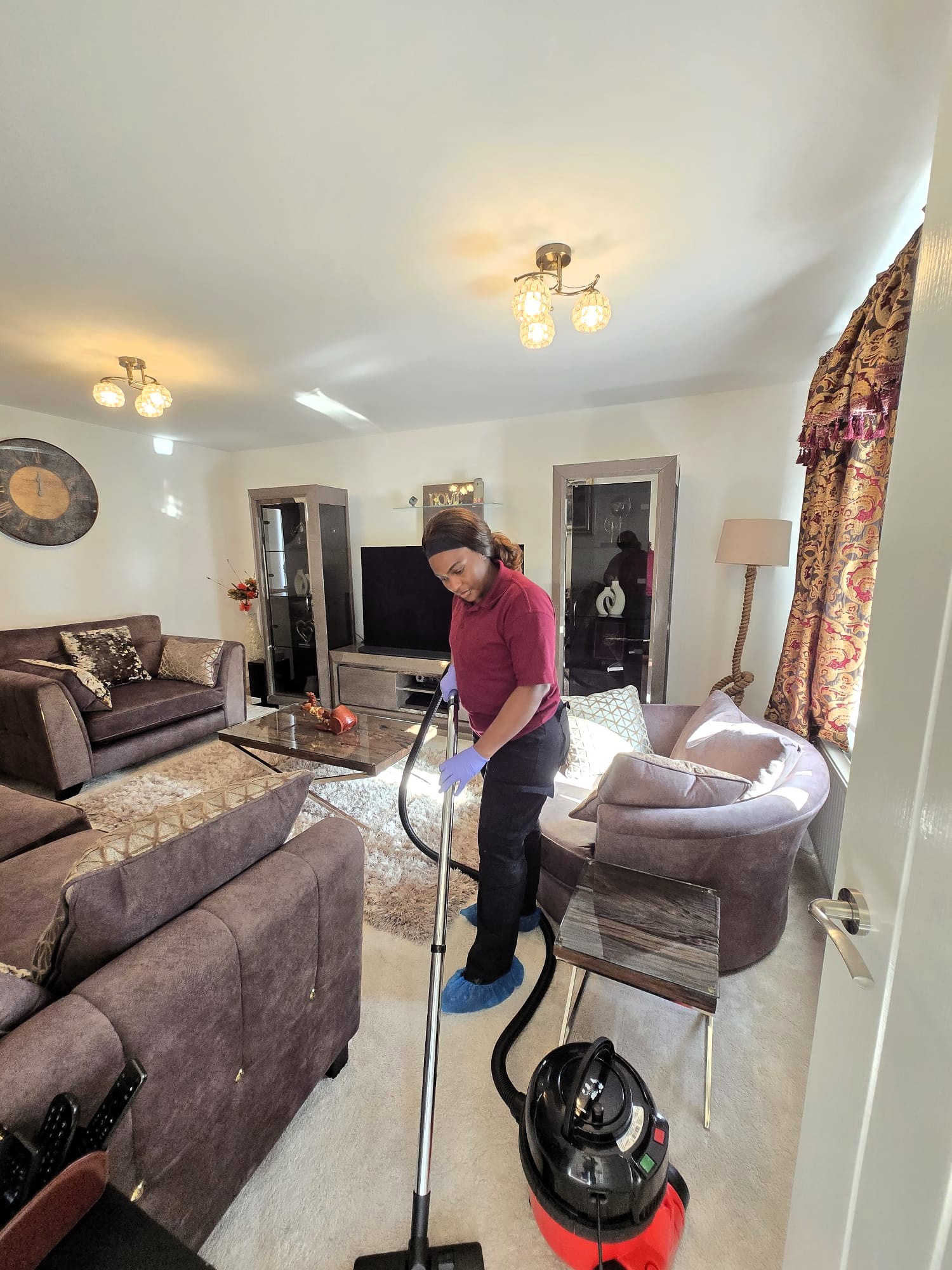 Zinomatt cleaner vacuuming a living room during a residential cleaning service