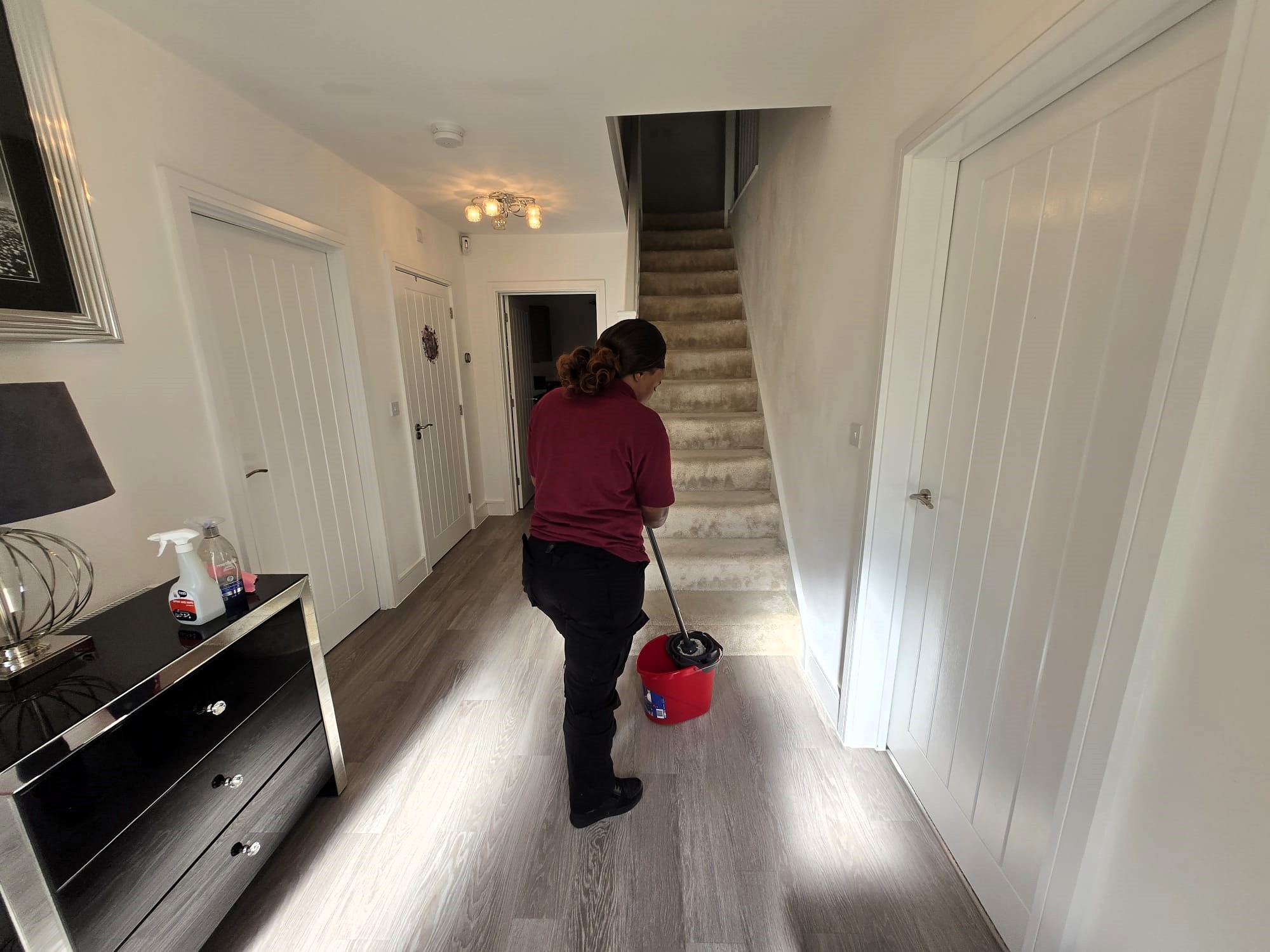Zinomatt cleaner mopping a hallway during a residential cleaning service